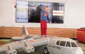 boy standing on airplane