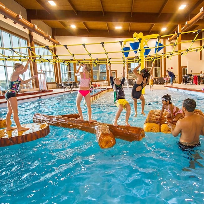 families enjoying indoor pool floatables