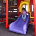 girl coming down open bed slide