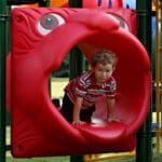 kid crawling through lion mouth