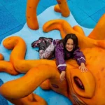 girl playing on octopus play sculpture