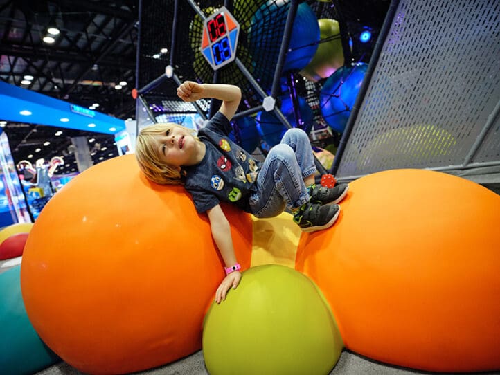 boy playing on interactive challenge course