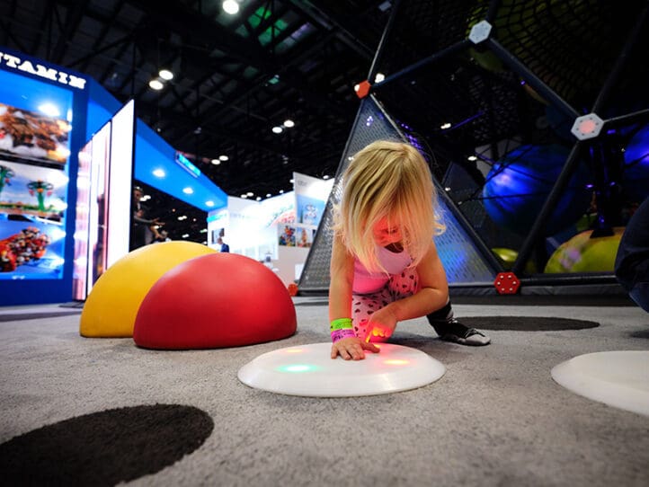 kid playing with interactive play equipment