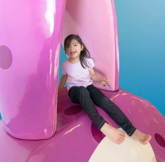 young child playing on the Toonies squid