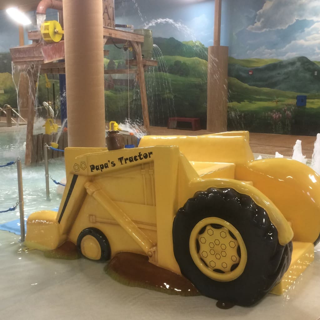 tractor theme water slide at a swimming pool