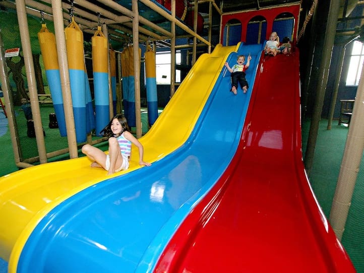 kids going down triple wave slide