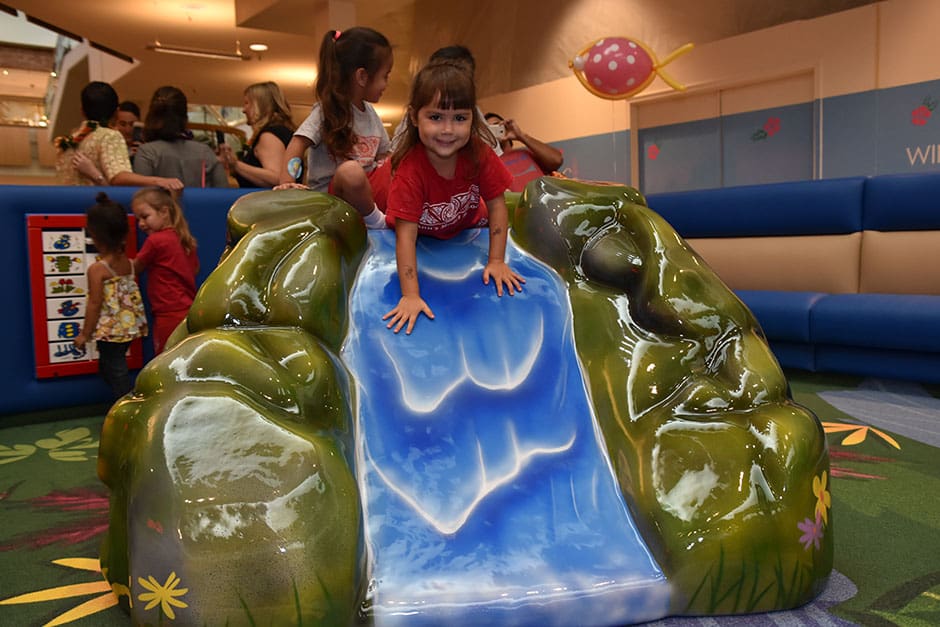 girl on wave slide at windward mall