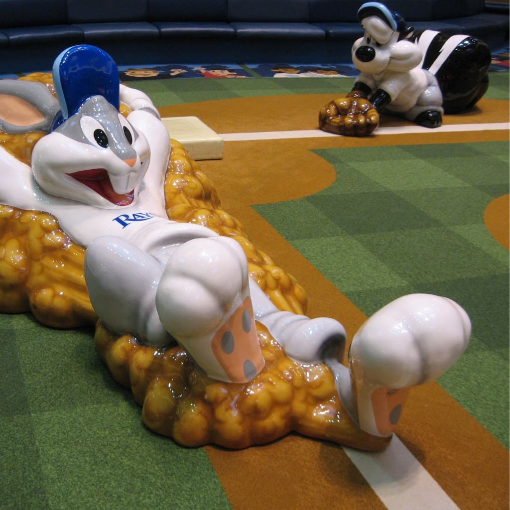 Bugs Bunny slides for home plate at a base baseball diamond, soft sculpture playground